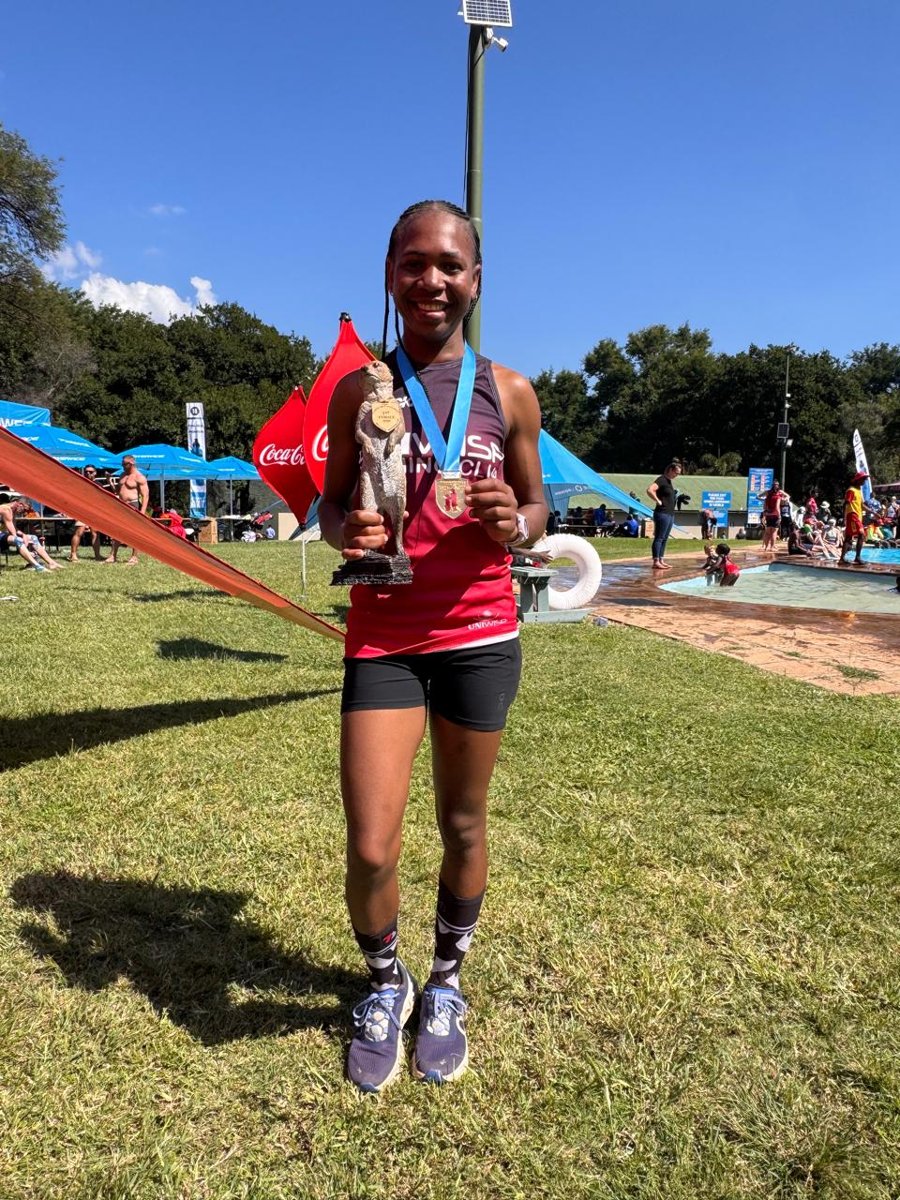 Nomvula Sithole celebrating a race win with her trophy and medal