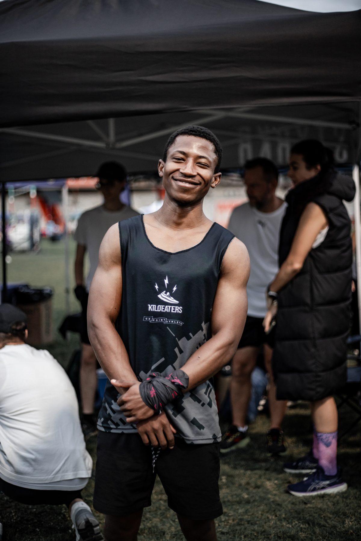 A Kiloeaters athlete smiling in Kiloeaters running kit
